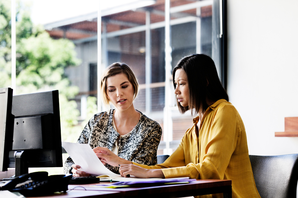 Businesswomen discussing over document