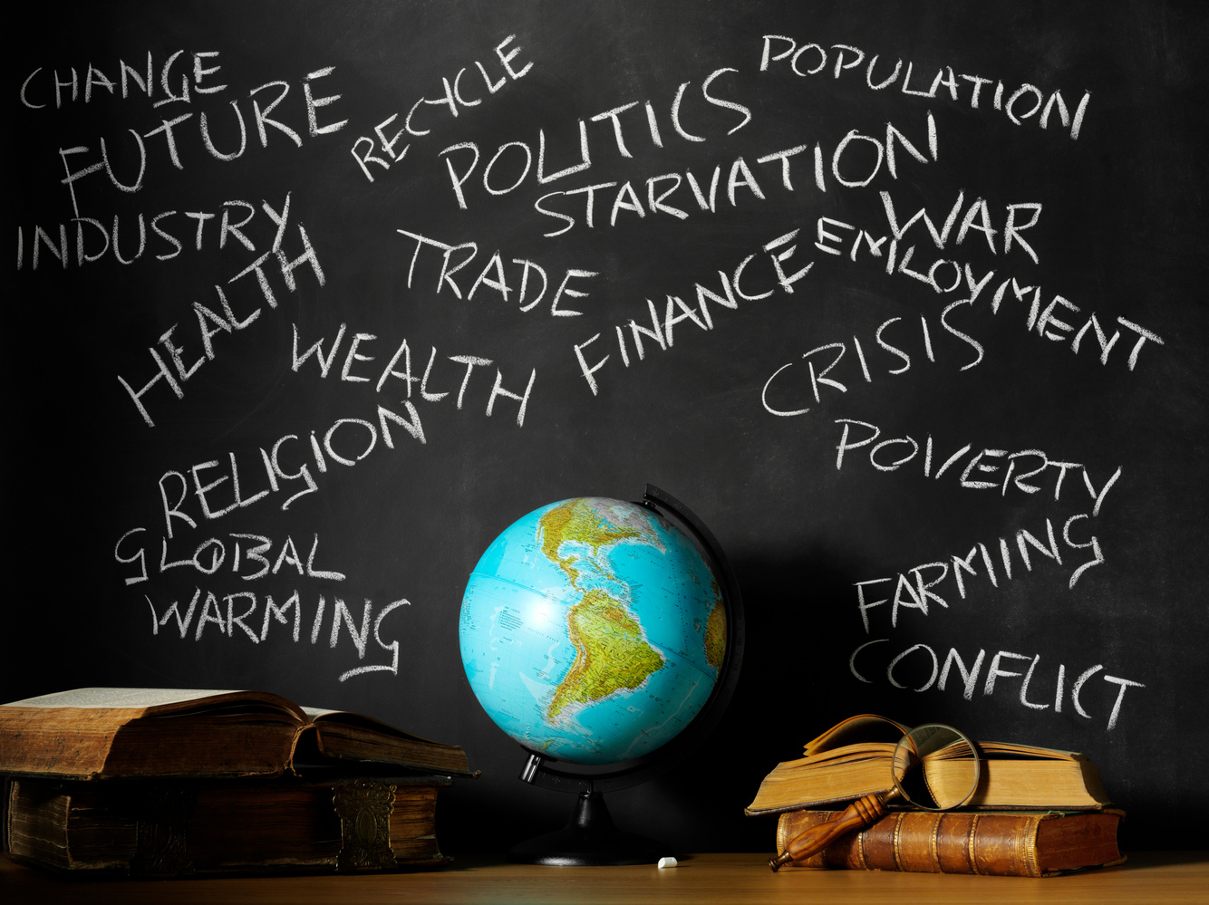 Desktop Globe with School and Business Subjects on a Blackboard