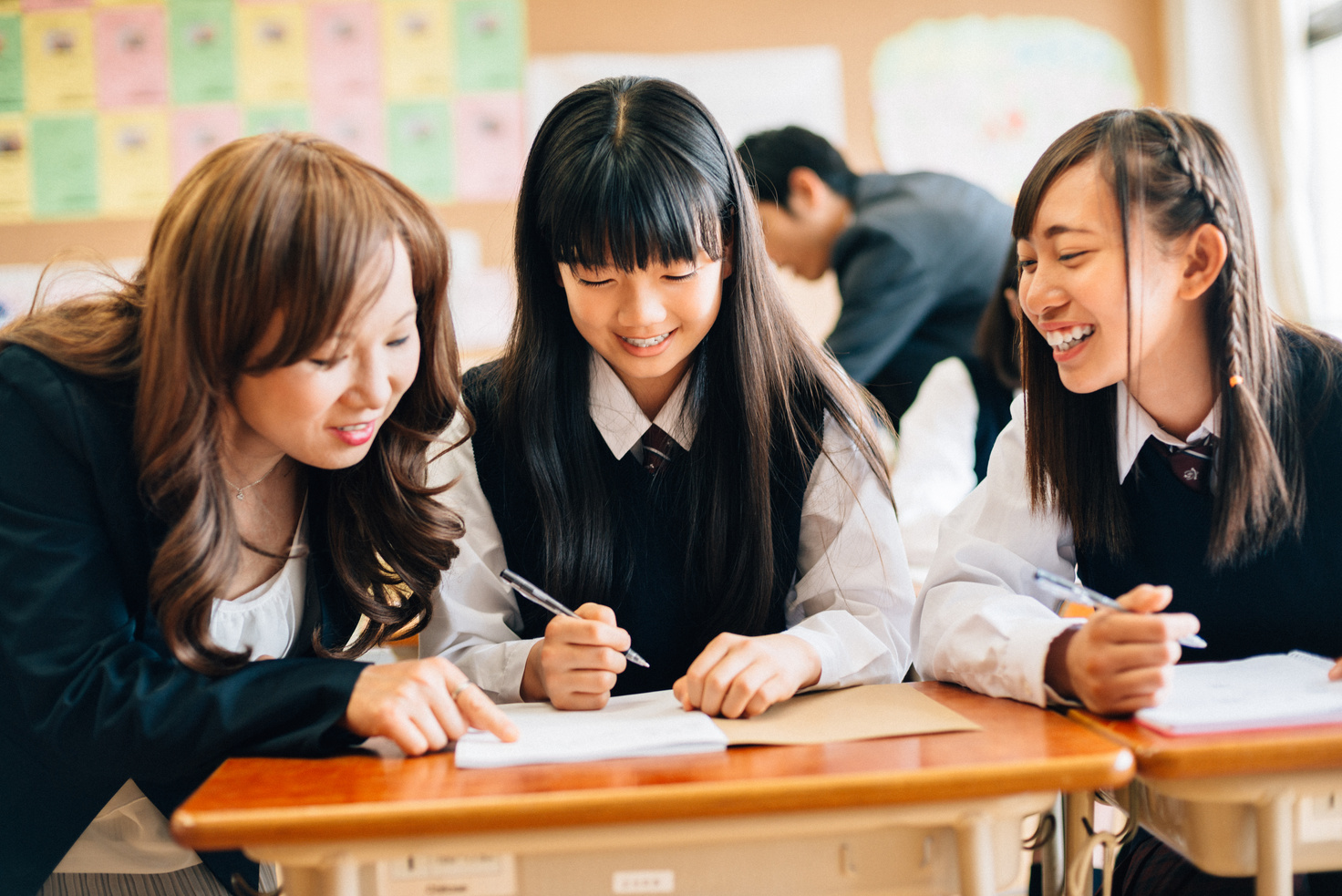 Teacher Assisting Students in Japanese Junior High School